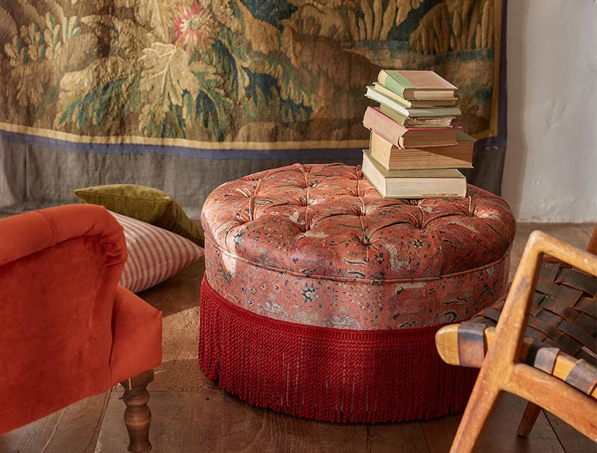 Burford Buttoned Footstool in V&A Threads of India Opulent Velvets Lahore Dynasty Flame with fringe in Sophie Bullion Fringe Currant